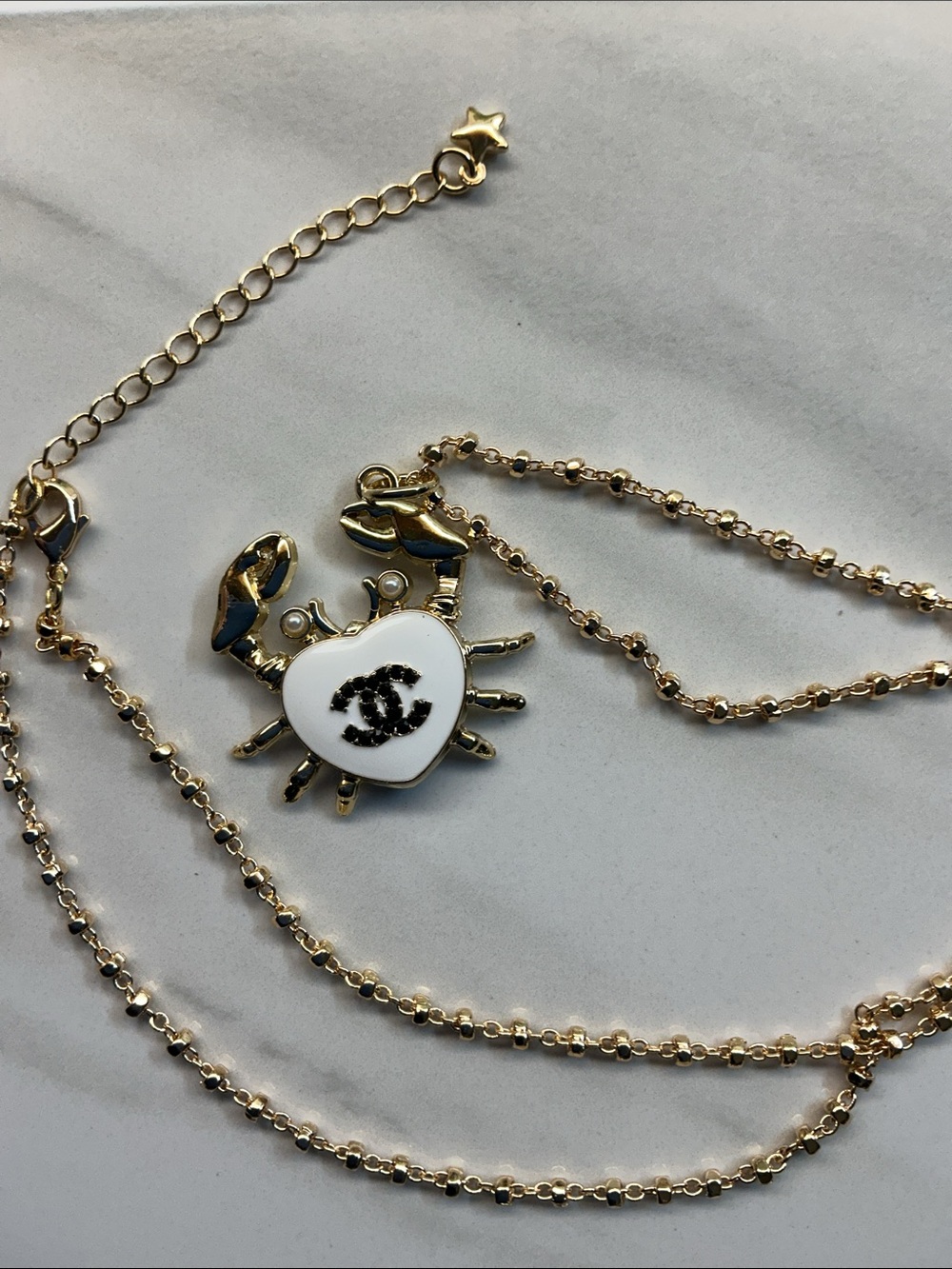 Gold-Tone Crab Pendant Necklace with White Enamel Heart and Black Logo - Picture 2 of 7